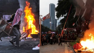 escena de una protesta violenta en yakarta, indonesia. un grupo de manifestantes en una calle llena de humo se enfrenta a una línea de policías con escudos. la imagen representa la crisis social de septiembre de 2025.