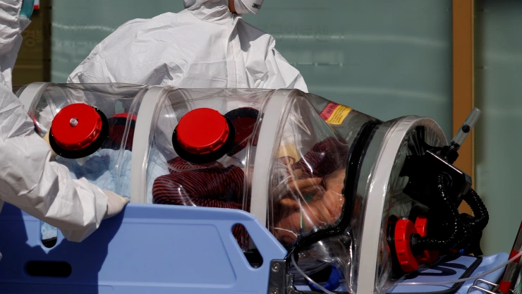 Medial workers carry a patients who are suspected of having coronavirus disease (COVID-19) in a Negative Pressure Isolation stretcher into a facility of Kyungpook National University Hospital in Daegu