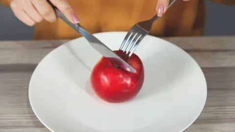 Mujer preparándose para comer una manzana