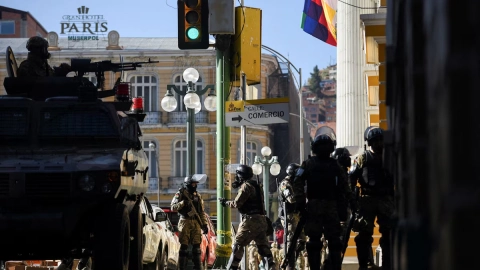 Vehículos blindados bolivianos, soldados se retiran de la plaza fuera del palacio presidencial