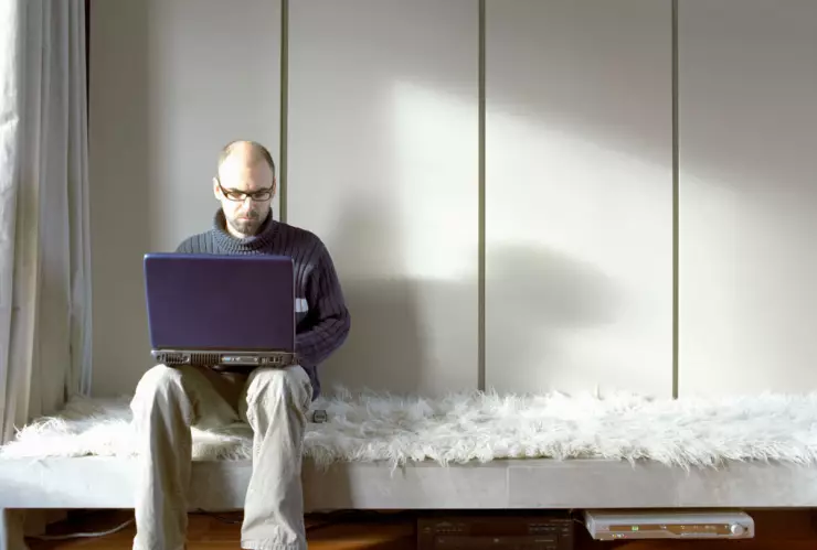Man on Laptop in Lounge Room