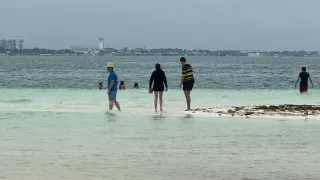 Frente frío 28 en Cancún, turistas disfrutan de playas en megapuente
