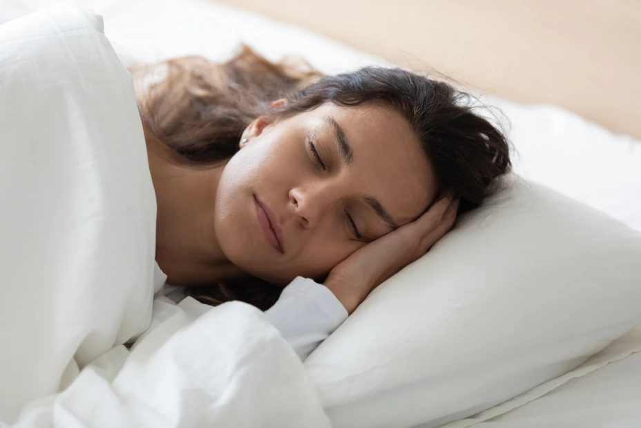 Side view tranquil young biracial woman lying in bed.