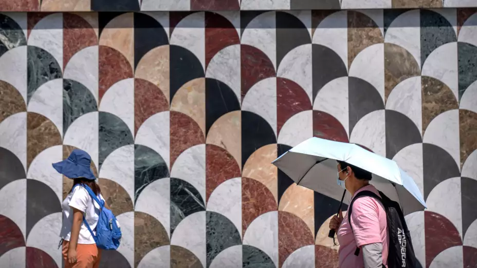 Sombreros y sombrillas para protección del calor en Beijing, China.