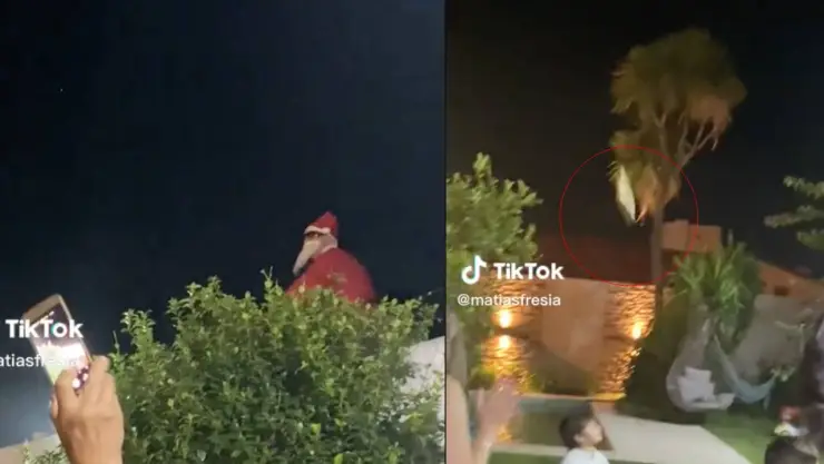 PAPA NOEL LE AVIENTA REGALO A NIÑO EN LA CABEZA