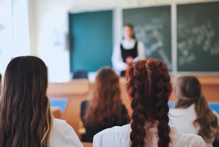 Unas alumnas atienden la clase de una profesora.