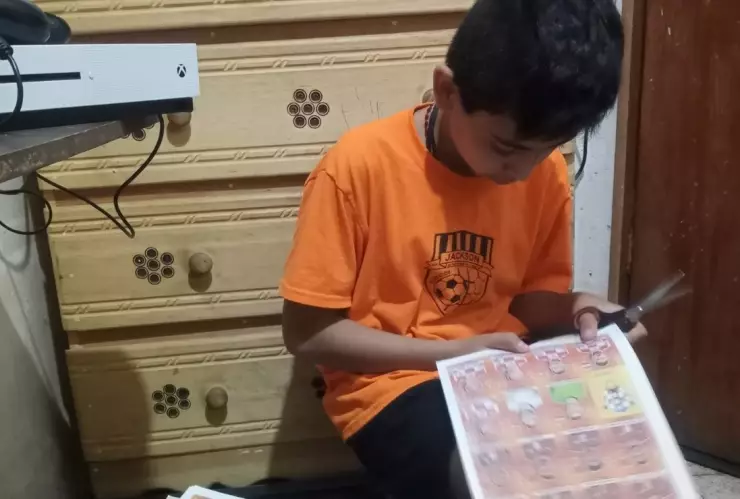 Papá imprime estampas álbum Qatar para hijo