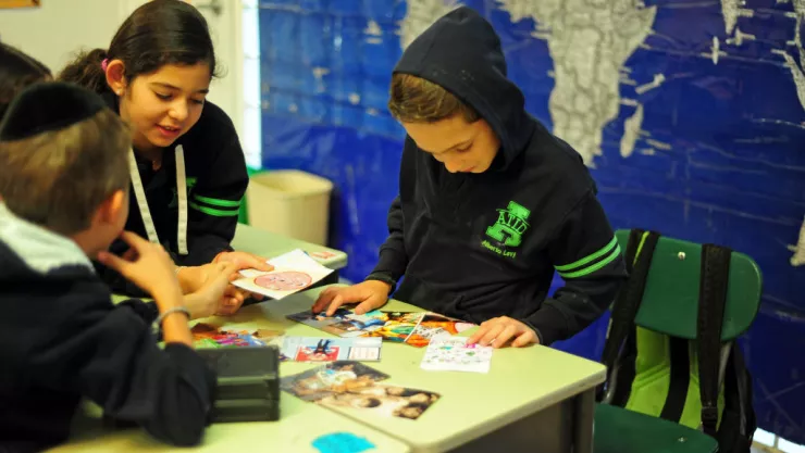 Mexico, Mexico City, children looking at photographs during Art in All of Us activities