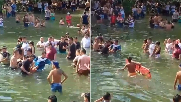 Personas ayudan a los lesionados a salir del río, tras el colapso del puente en Colombia.