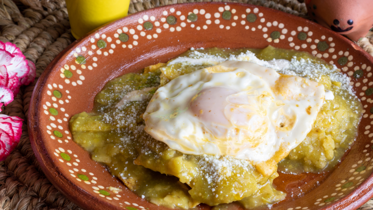 Mexican food. Green chilaquiles with over medium eggs