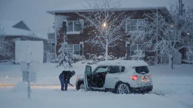 Woman shovels snow in Arlington Heights