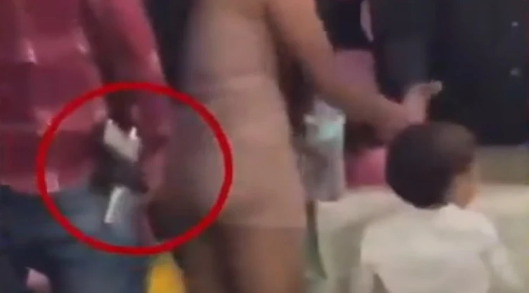 Captan a hombres armados en graduación de primaria en Tamazula; su presencia desata polémica. En la imagen se observa cómo un presunto padre de familia carga con una pistola mientras junto a su pareja a compañan a un niño a recoger un diploma.