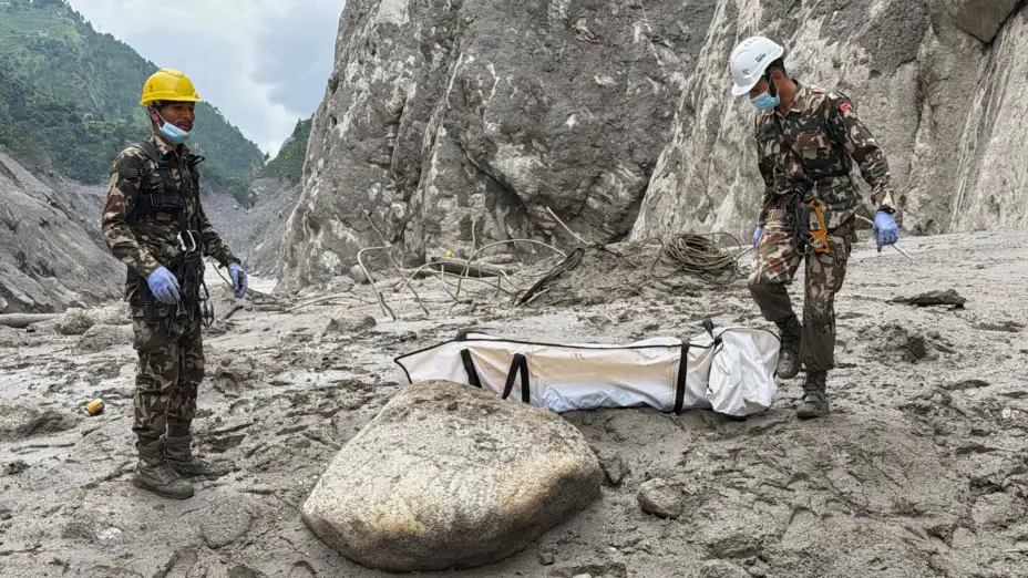 Soldados de Nepal trasladan un cadáver víctima de inundaciones.