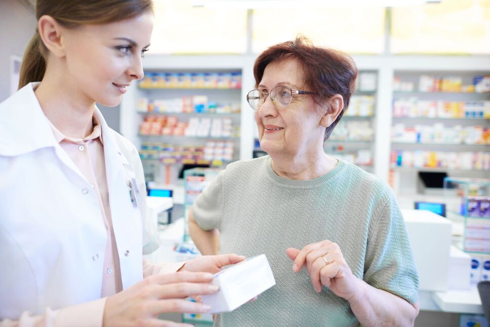 female-pharmacist-assisting-senior-woman.jpg
