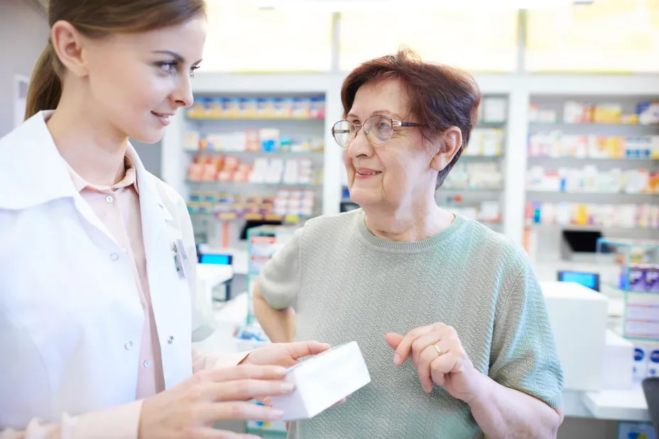 female-pharmacist-assisting-senior-woman.jpg