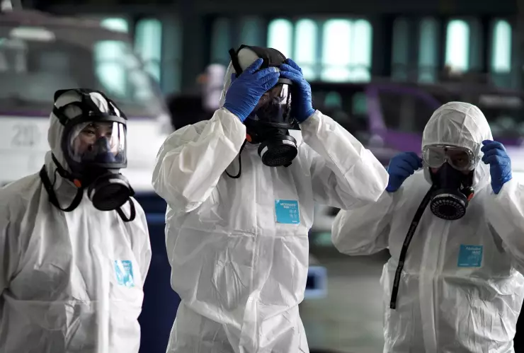 FILE PHOTO: Members of the Thai Airways crew prepare themselves before disinfecting the cabin of an aircraft of the national carrier during a procedure to prevent the spread of the coronavirus at Bangkok’s Suvarnabhumi International Airport