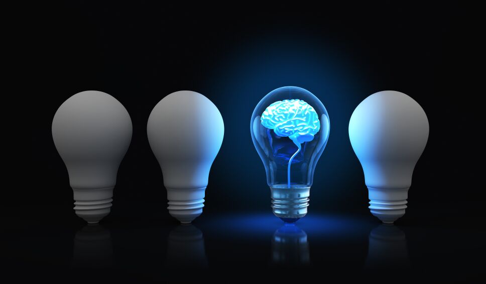 Light bulb with shining brain inside