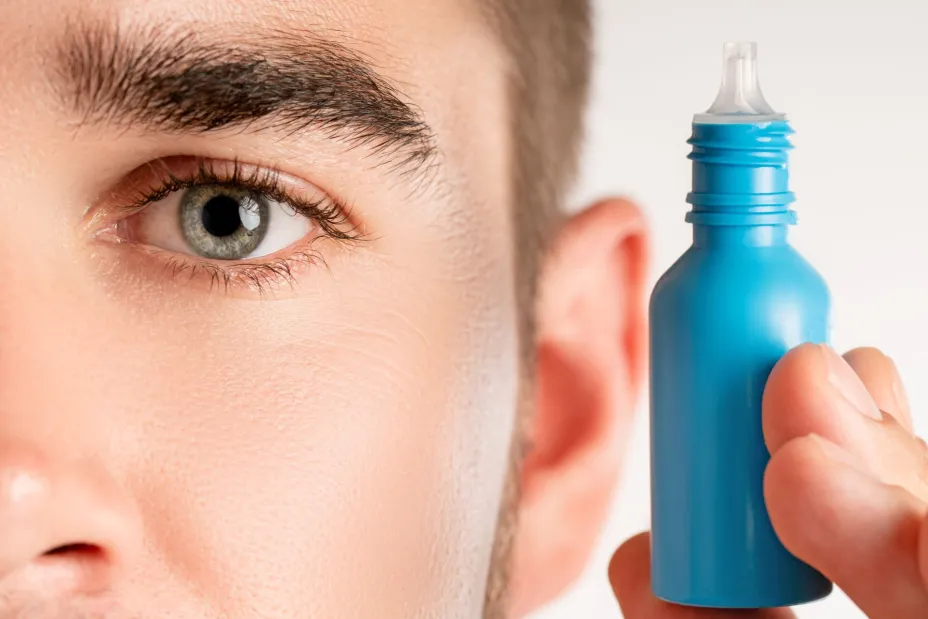 male-eye-and-small-bottle-of-eyedrops-2023-11-27-05-25-36-utc.jpg