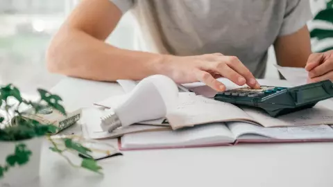 un hombre saca las cuentas para pagar la boleta de luz