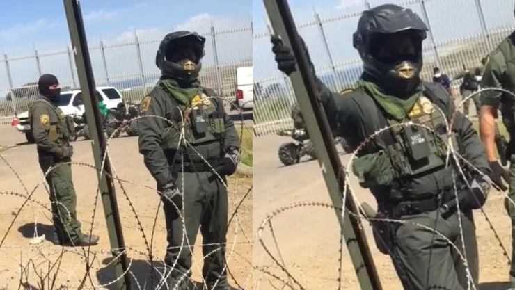 Joven platica con agente fronterizo en el muro entre México y EU