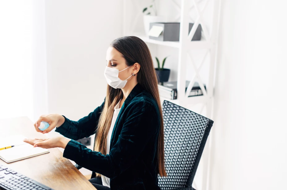 Woman in medical mask at the office