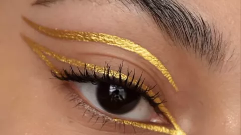 Delineador oro en ojos cafés