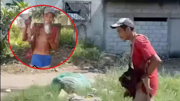 ¡DE MIEDO! Captan a un hombre comer una cabeza de perro mientras pasea en la calle (VIDEO)