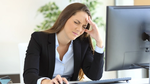 Businesswoman suffering headache
