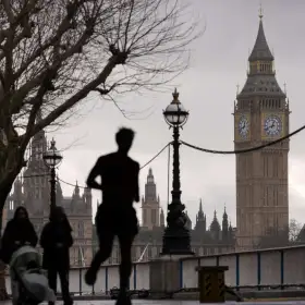 Gente camina a la orilla del río Támesis junto a la torre del Big Ben.