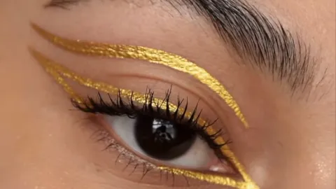 Delineador oro en ojos cafés