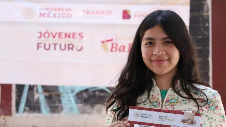 jóven mostrando su sobre que la acredita como beneficiaria del programa Jóvenes Construyendo el Futuro