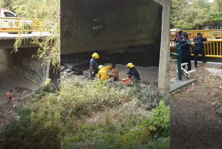 Hombre herido debajo de un puente siendo atendido por rescatistas.