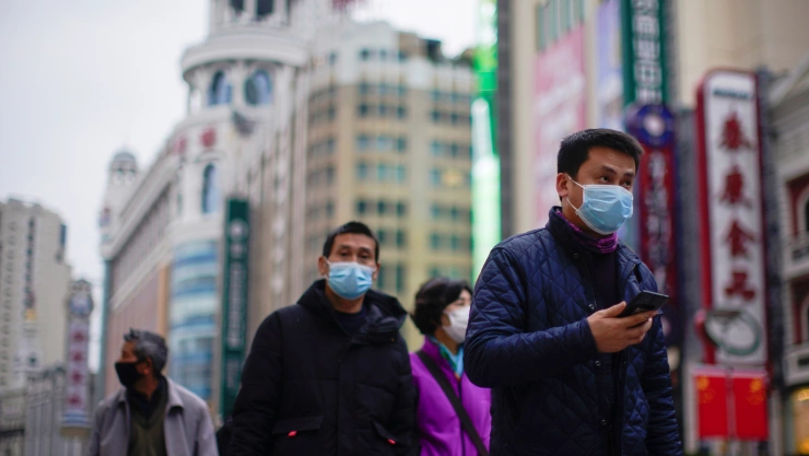 People wear masks at a main shopping area, in downtown Shanghai