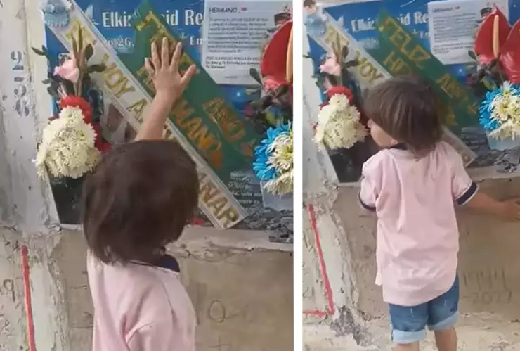 Niño visita la tumba de su papá