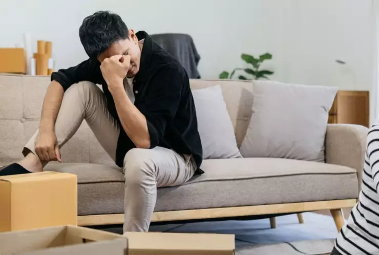 Un hombre te pone la mano en la cabeza en medio de una mudanza.