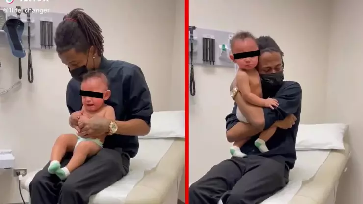 Papá llora con su bebé por vacuna