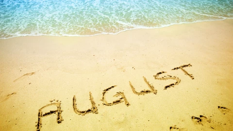 August handwritten in the sandy shoreline