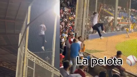 Hombre es captado escalando una red para subir por la pelota en un esadio de baseball