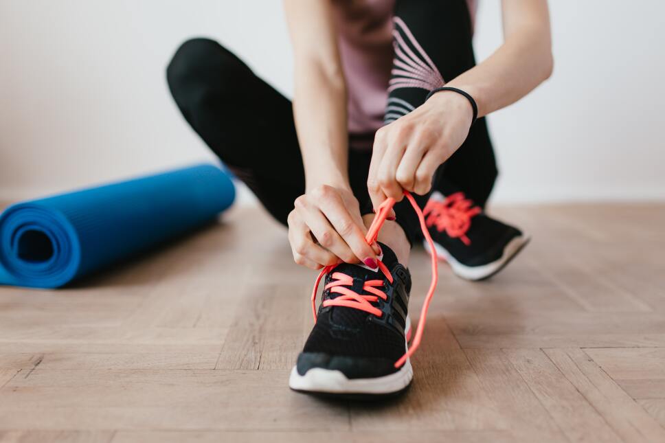 crop-young-sportswoman-tying-shoelaces-on-sneakers-4498555.jpg