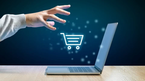 Online shopping concept. Search in shops through the Internet. Hand and laptop.