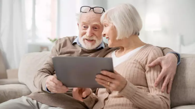 Una pareja de adultos mayores utilizan la computadora