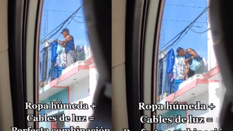 Hombre tiende ropa en cables de luz.
