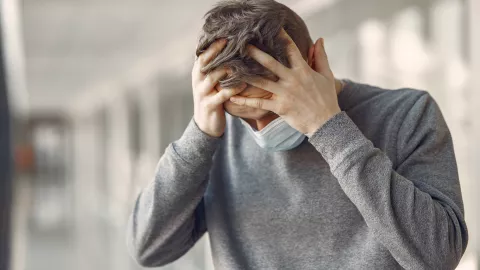 Man in a mask standing in the hall of hospital
