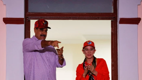 Nicolás Maduro y su esposa Cilia Flores saludan a sus partidarios durante una marcha, en conmemoración del primer aniversario de su victoria en las disputadas elecciones presidenciales del 28 de julio, en Caracas