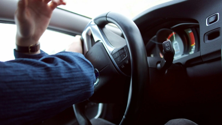 Persona sujetando volante de auto.