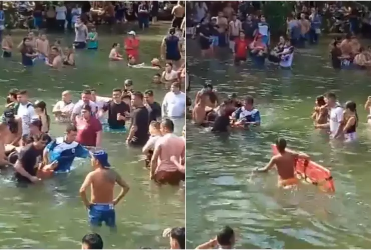 Personas ayudan a los lesionados a salir del río, tras el colapso del puente en Colombia.