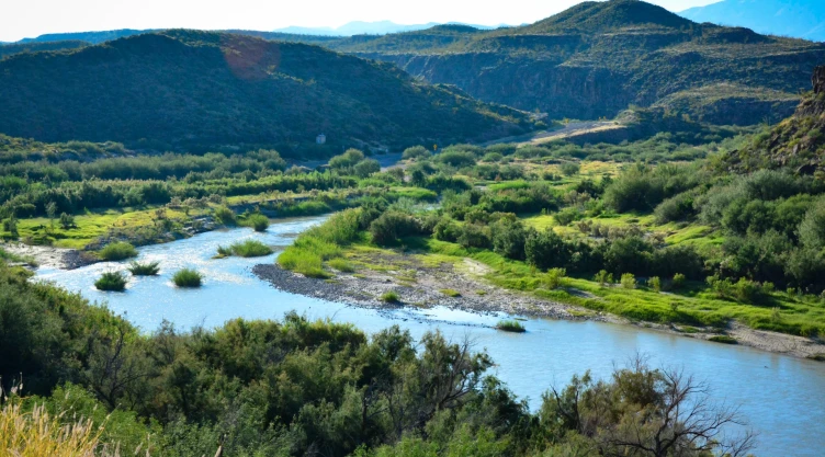 El río en el pueblo Lajitas, entre dos montañas con variedad de vegetación verde