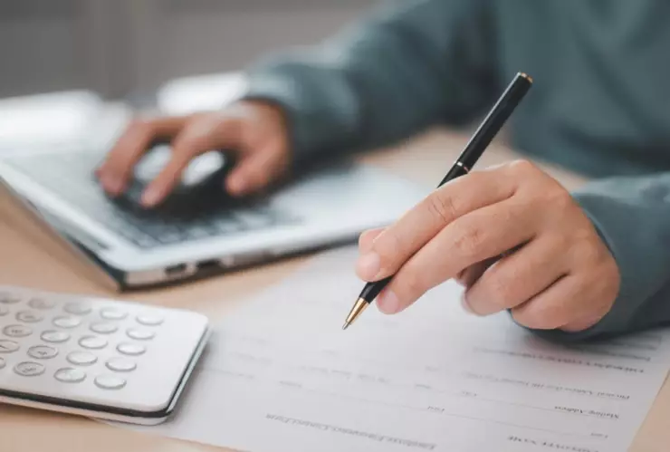 Una persona rellena un formulario.