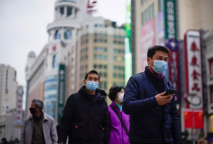 People wear masks at a main shopping area, in downtown Shanghai