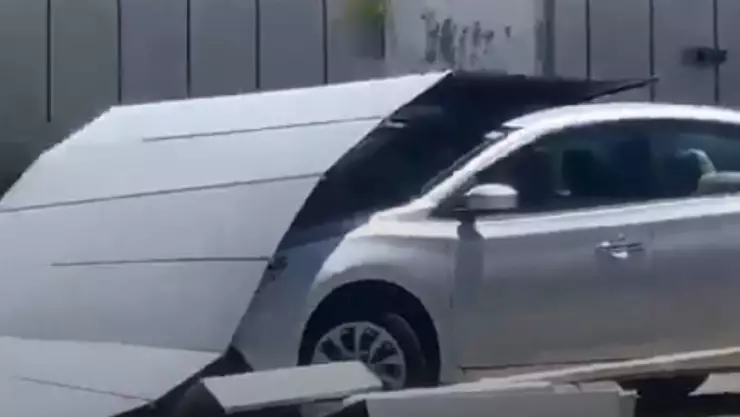 Estructuras metálicas caen sobre un auto en plaza comercial